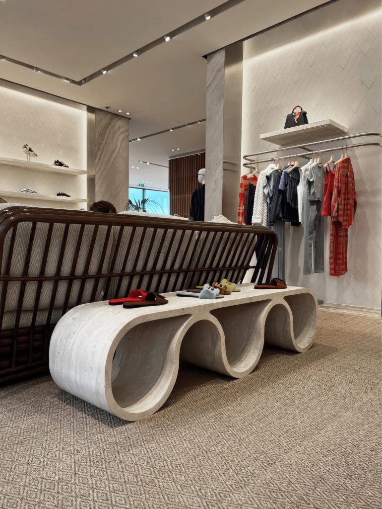 Sculptural stone bench inside the Fendi Cannes store.