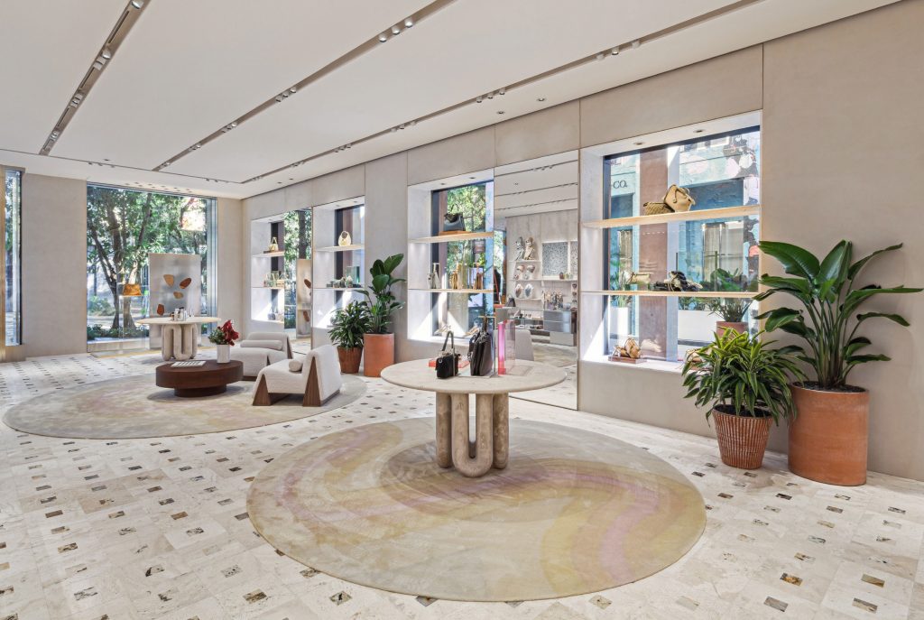 Round travertine table beside the boutique windows in Miami.