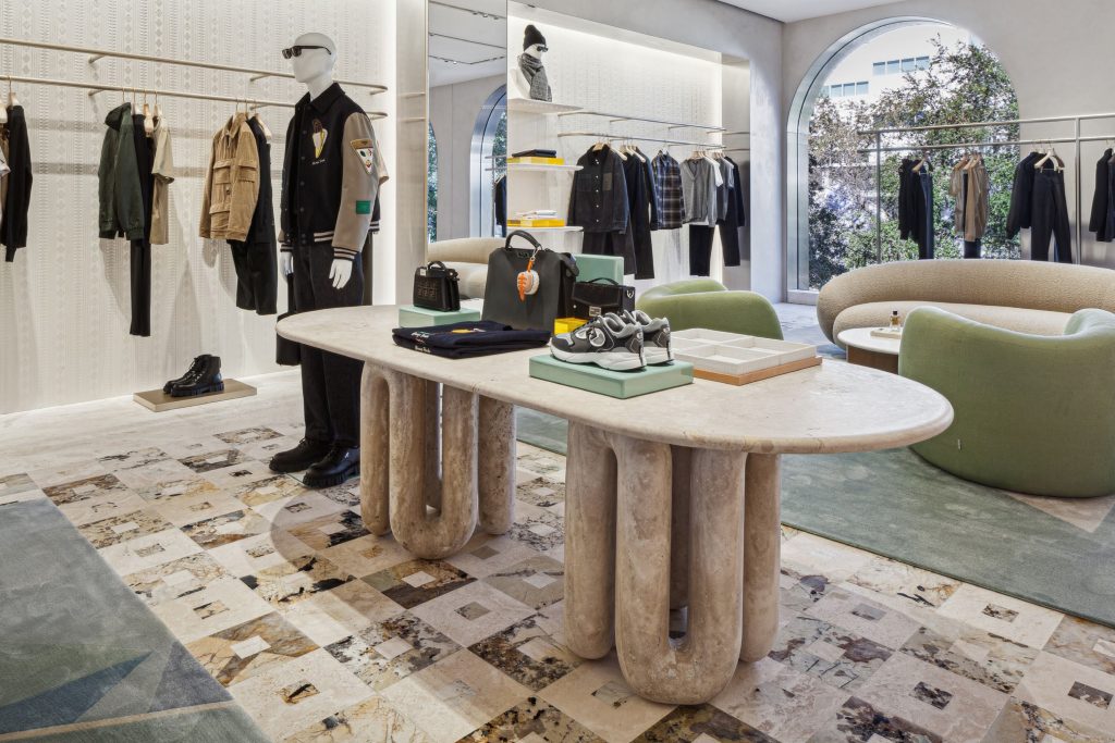 Sculptural travertine display table in the Fendi Miami menswear space.