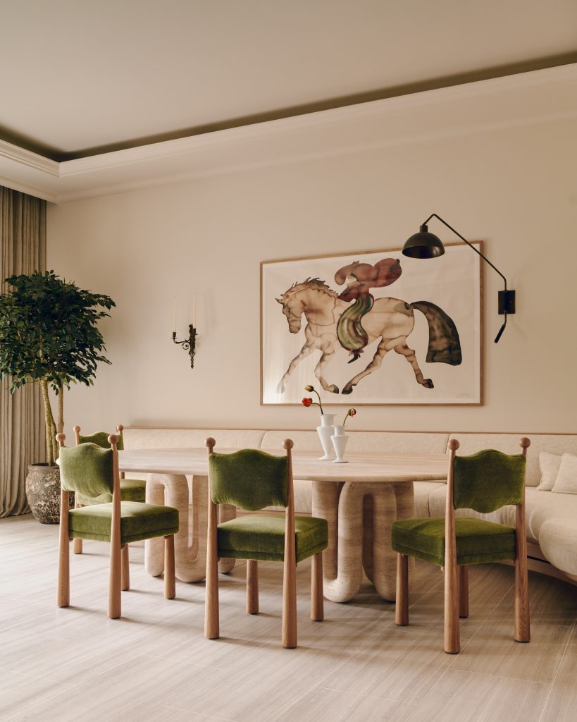 View of the travertine table and green upholstered chairs at Mulberry Townhouse.