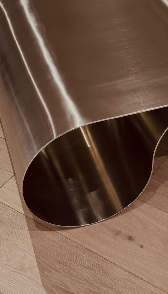 Close-up of the curved metal surface of the Eternity Chair.